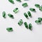 scattered green capsules on a pristine white background, ideal for healthcare and supplement design