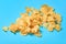 Scattered many fried potato chips on blue background