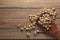 Scattered peeled peanuts, peanuts on a wooden background with a wooden spatula.