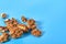 Scattered pieces of pulp of walnut on blue background