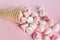 Scattered pink and white decor for baking, meringue in waffle cookies