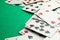 Scattered playing cards on green table, closeup. Space for text