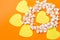 Scattered popcorn and illuminating hearts on orange background. Valentine& x27;s Day.