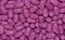 Scattered purple candies as seen from above.