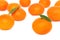 Scattered ripe mandarins on white background