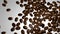 Scattered roasted coffee beans background with copy space for text
