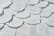 Scattered round cotton pads for hygiene lies on dark concrete table. Close-up