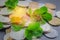 Scattered Russian coins on a gray background with leaves of clover. Good luck, St. Patrick\'s day.