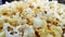 Scattered salted popcorn with cheese, texture background