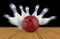 Scattered skittle and bowling ball on wooden floor