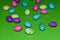 Scattered Speckled Candy Eggs On Green Surface