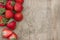 Scattered strawberries on wooden table (can be used as background, card)