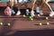 Scattered Tennis Balls On Court By Feet Of People