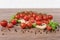 Scattered tomatoes on the wooden table.