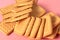 Scattered whole square cookies on pink desk on kitchen