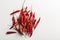 A scattering of hot chili peppers top view on a white background horizontal orientation