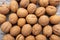 A scattering of walnuts on a wooden background close-up