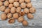 A scattering of walnuts on a wooden background close-up