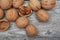 A scattering of walnuts on a wooden background close-up