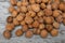 A scattering of walnuts on a wooden background close-up