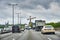 Scene on the Berlin A100 freeway with various vehicles at the start of rush hour traffic