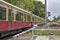 Scene at a Berlin railroad crossing with closed barrier, which is passed by a train of the company Deutsche Bahn