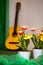 Scene detail: colorful flowers and guitar