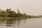 Scene of long river in the countryside around with trees