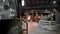Scene on metallurgical production. In the gloomy shop, workers monitor the operation of the furnace. The furnace under a