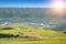 Scenery of alpine meadows with Mongolian yurts under sunlight