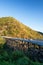 Scenery of the bear mountains bridge at dusk, golden sunset shines on the cars driving across the bridge and mountain range