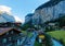 Scenery of beautiful Lauterbrunnen village in the glacial valley with Staubbach waterfall hanging down a rocky cliff