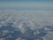 Scenery of blue sky and cloud as seen through window of an aircraft above Europe