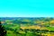 Scenery in Carassai with trees, fields, human settlements and Marche hills