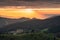 Scenery of colorful sunrise over mountain farmland in countryside