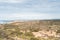 Scenery of the dry steppe in the west of Portugal in the Odemira region. View of fields, city and Atlantic Ocean. Following the