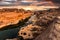 Scenery of Eroded large rocky rapids gorge with Mekong river and colorful sky in the sunset