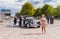 Scenery with fiance, fiancee, vintage car, photographer and ordinary people on a Dnepr river embankmen