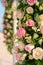 Scenery of flowers of white and pink roses on a wedding arch