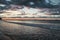 Scenery of gloomy sky over the wavy sea at sunset, Isle of Wight, England