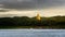 The scenery of the golden Phuthakaya pagoda shining in the sunset time at Sangkhlaburi, Kanchanaburi, Thailand