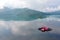 Scenery of a lotus blooming on an infinity pool and foggy mountains in background