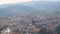 Scenery overlooking big city on hot summer day with mountains at back, panorama