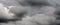 Scenery panoramic view of thunderstorm clouds in dusk sky during rain. Dramatic panorama of natural cloudiness weather