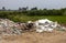 Scenery of piles of concrete debris and white tiled ceilings being dumped together