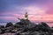 Scenery of a popular public statue of a golden mermaid on stone at Samila Beach in Songkhla Province at sunrise with island and sh