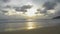 Scenery of the quiet beach with little waves splashing on the sand in the evening.