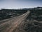 scenery with road and black rocks and mountains