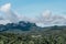 Scenery of small villages in countryside with the misty mountain background in Thailand.