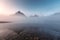 Scenery of sunrise over Rocky mountains in foggy reflection on Lake Magog at Assiniboine provincial park